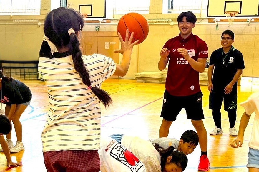 越谷会場で選手と子ども達がバスケットボール教室に参加している写真